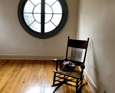A warm, inviting corner featuring a handcrafted wooden rocking chair.