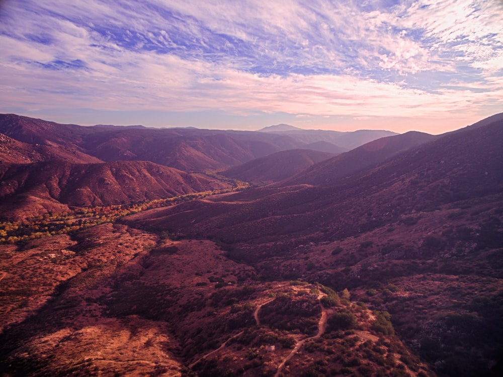 brown and green mountains under blue sky during daytime