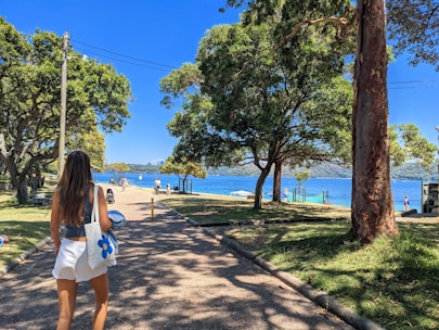 woman in white tank top and white shorts standing on brown concrete floor during daytime