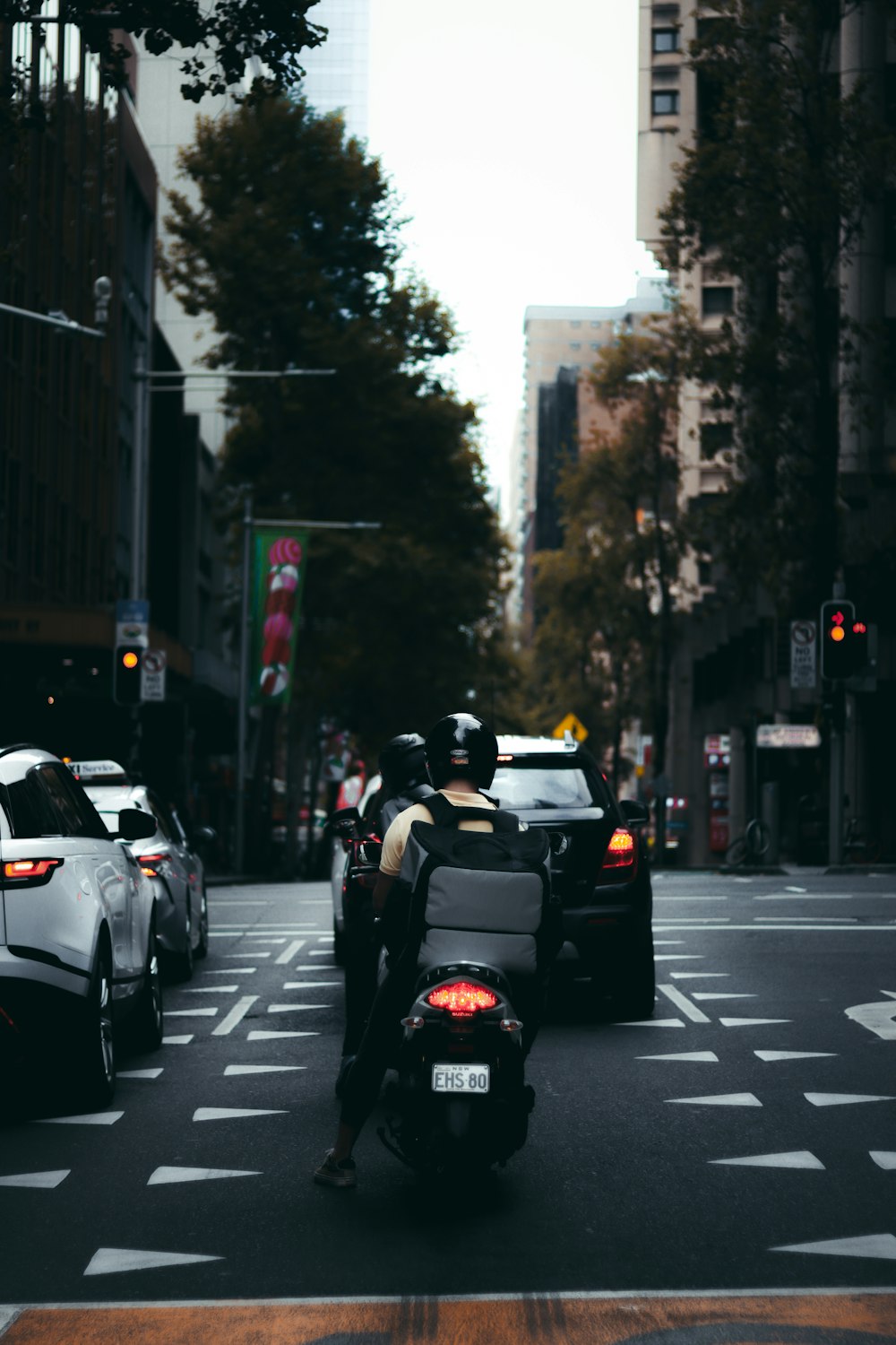 people riding on motorcycle on road during daytime