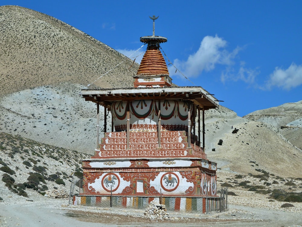red and yellow temple near mountain under blue sky during daytime