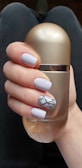 person holding silver and black bottle