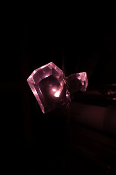 A soft pink rose quartz crystal glowing gently in natural light.