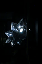 A protective amulet glowing softly against a dark background.