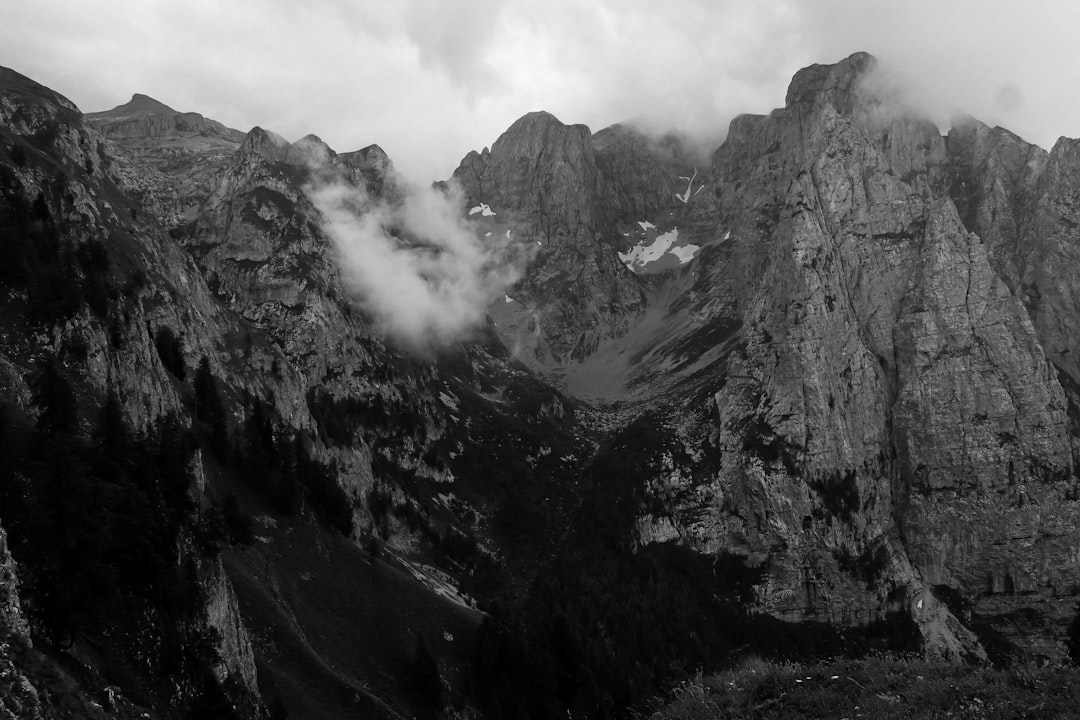 grayscale photo of mountains and clouds
