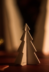 Minimalist Christmas scene with soft beige decorations and gentle lighting.