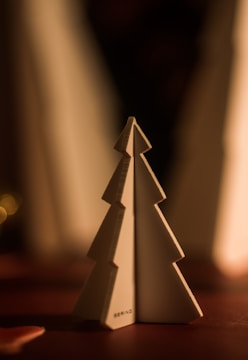 Minimalist Christmas scene with soft beige decorations and gentle lighting.