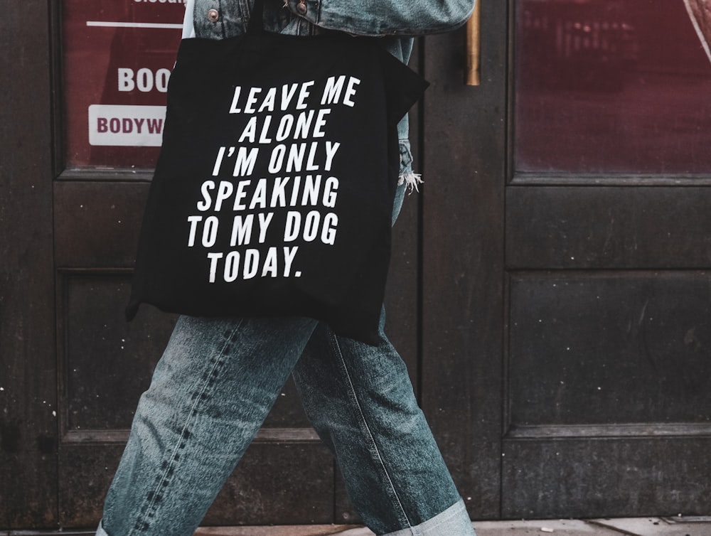 person in blue denim jeans and black jacket