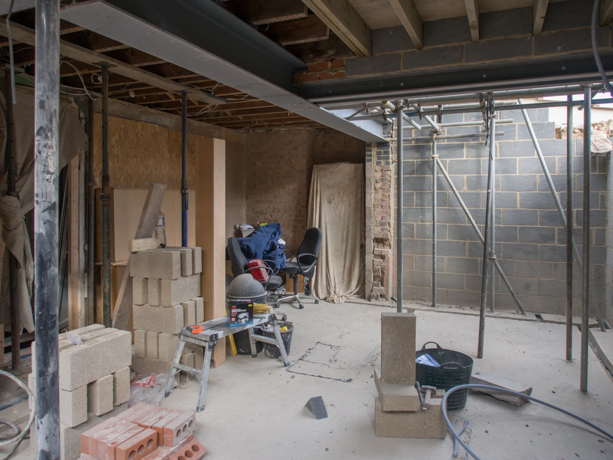 A basement under renovation with block walls and supports