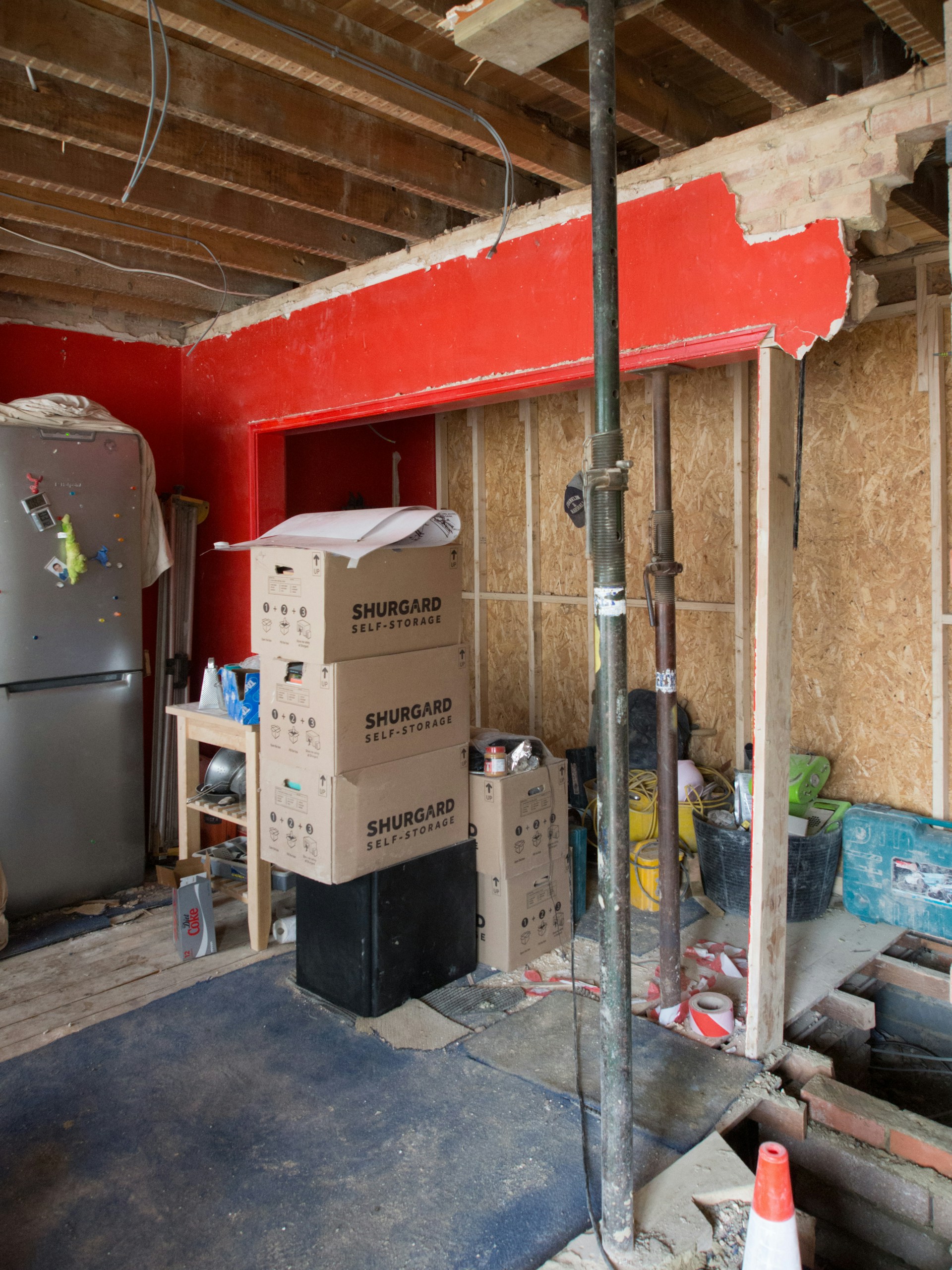 gray top mount refrigerator beside brown cardboard box