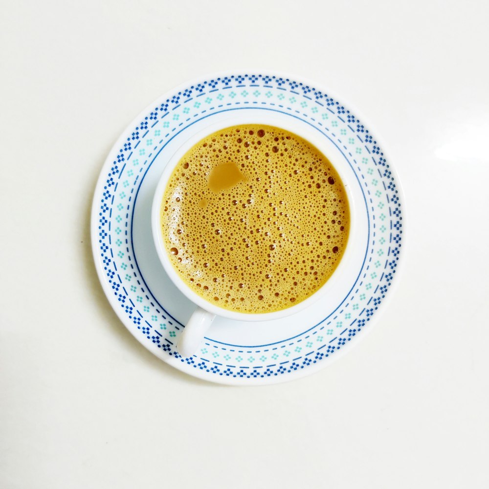 white ceramic cup with brown liquid