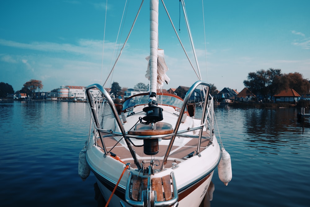 white and brown boat on water during daytime