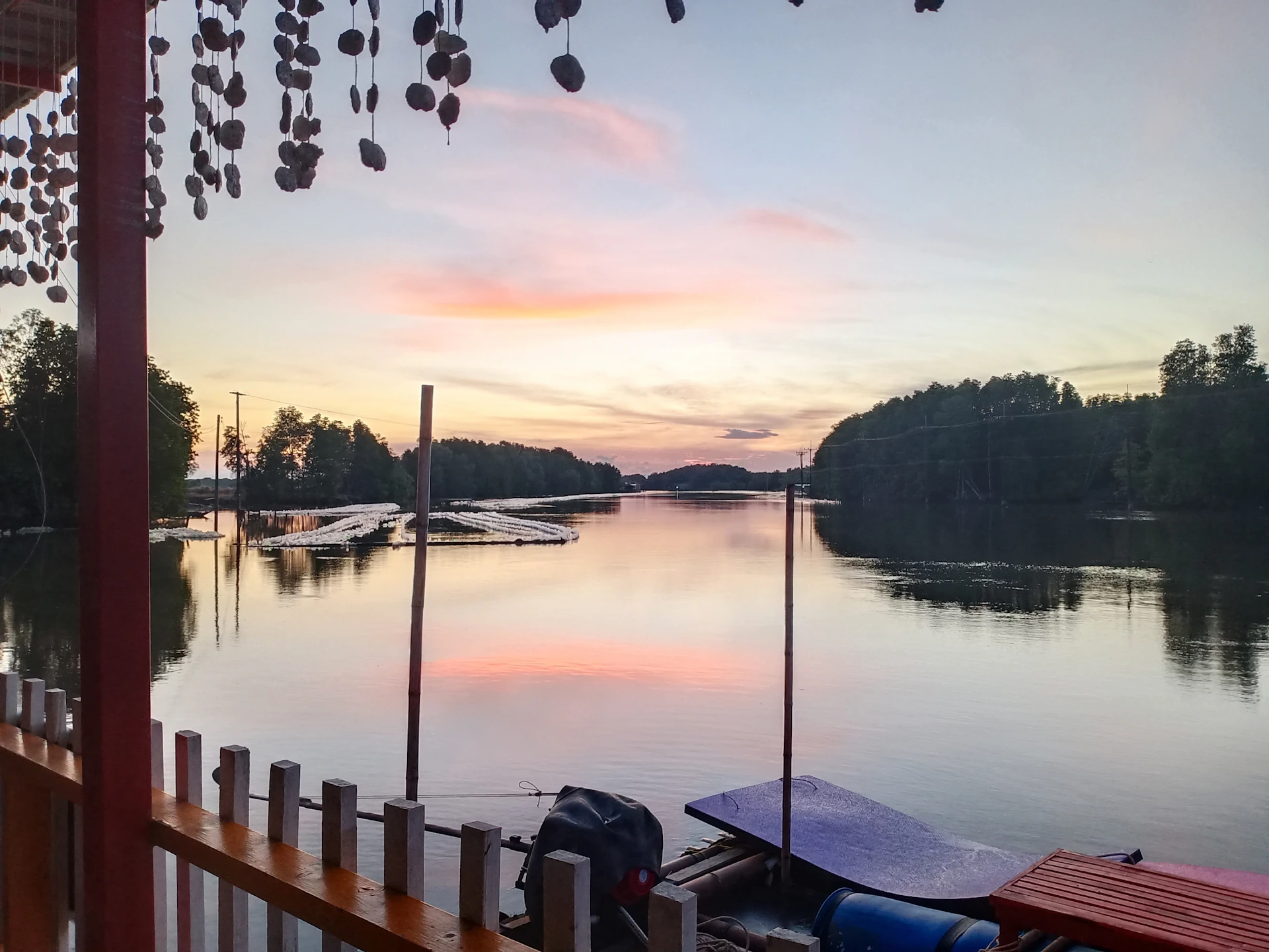 A twilight shot of the lodge exterior, softly lit, with the peaceful water and a private dock inviting quiet reflection.