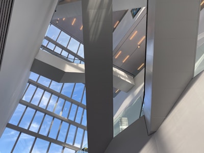 An architect reviewing blueprints with a team in a modern office space filled with natural light.