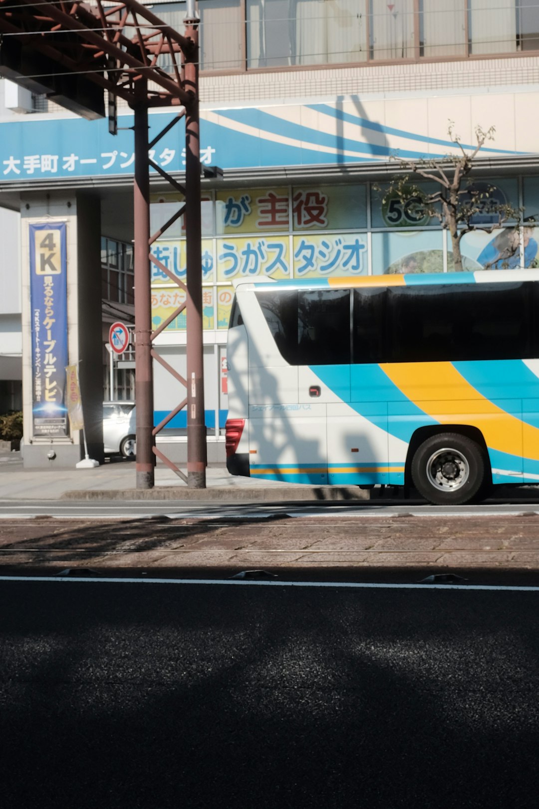 blue and white bus on road during daytime