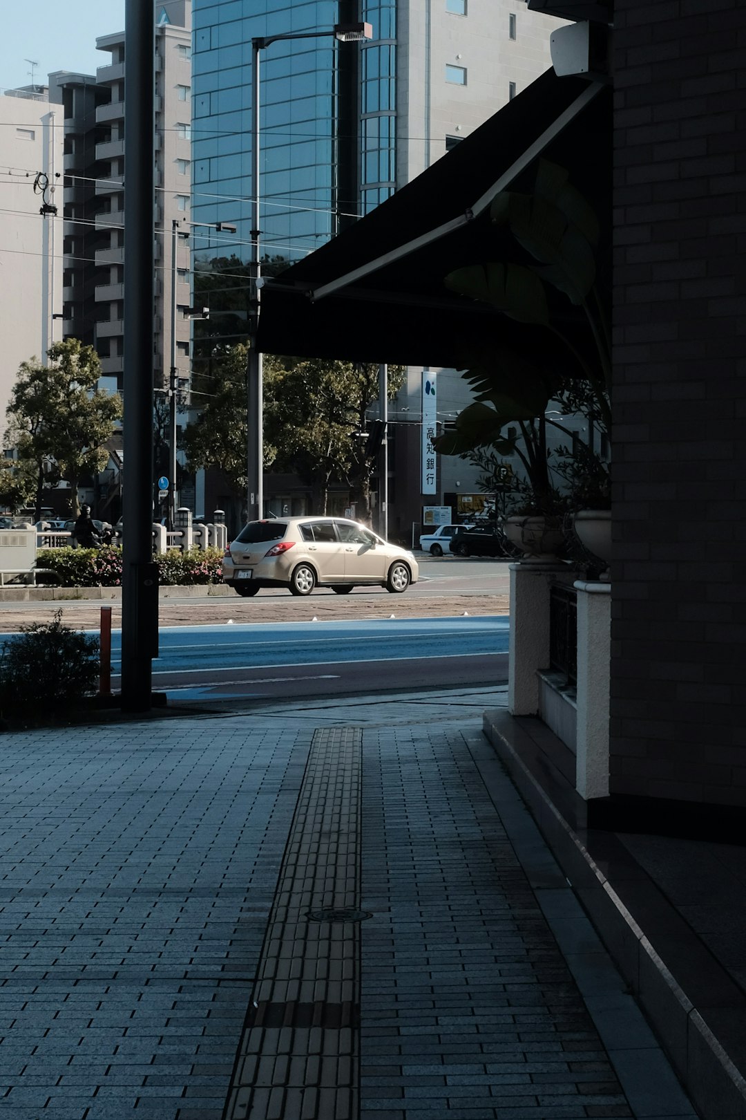 white sedan on road during daytime