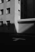 Black and white photograph of an urban street scene with artistic shadows