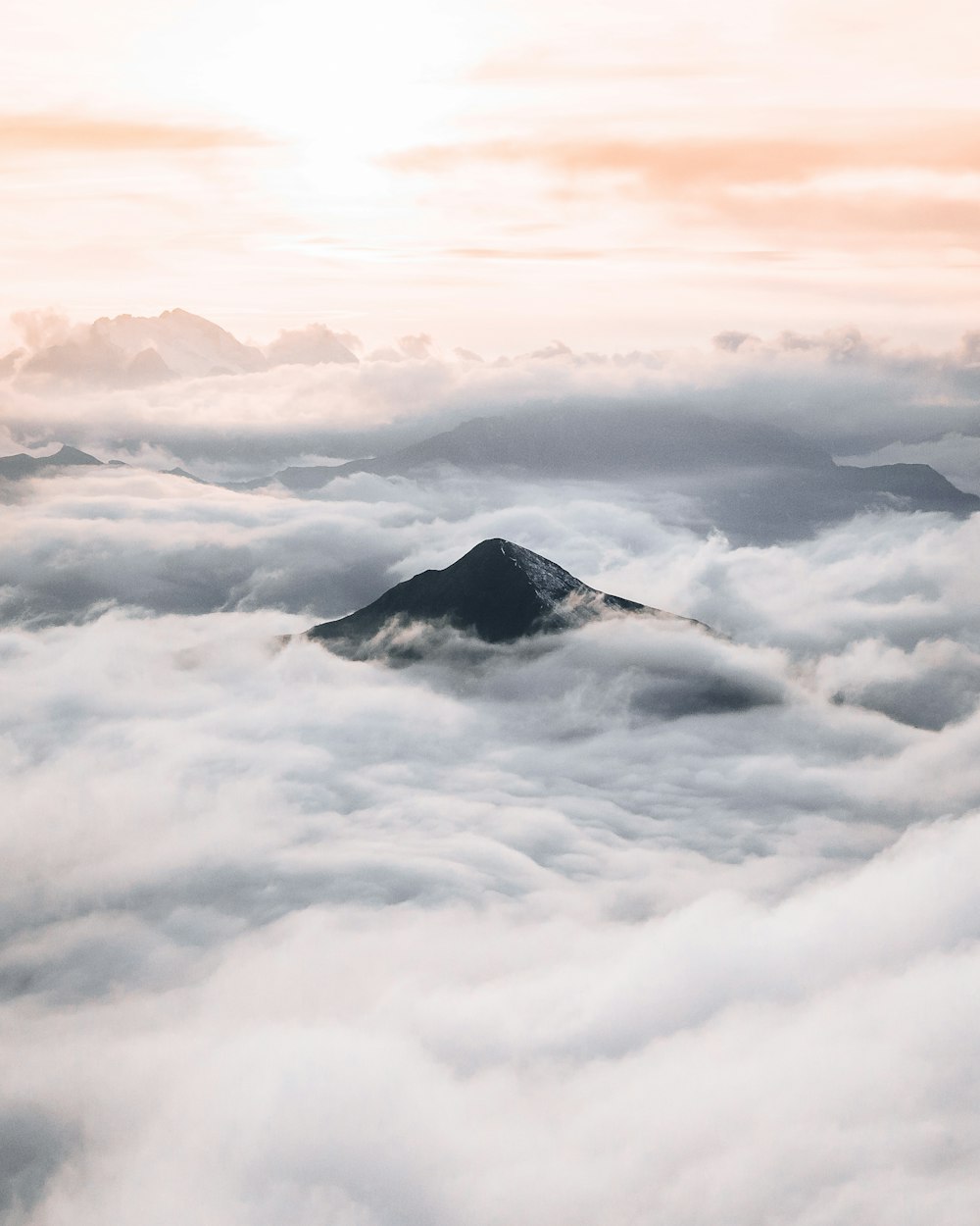 white clouds over black mountain