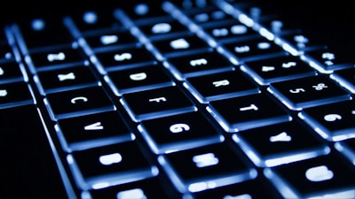 Picture of a computer keyboard with backlit keys.