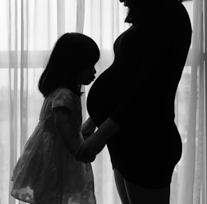 woman in white dress standing beside woman in black dress