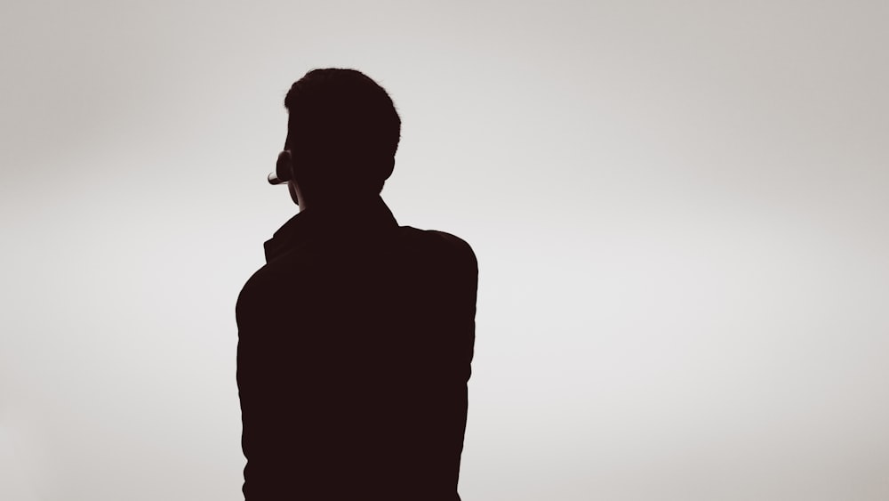 silhouette of man wearing sunglasses