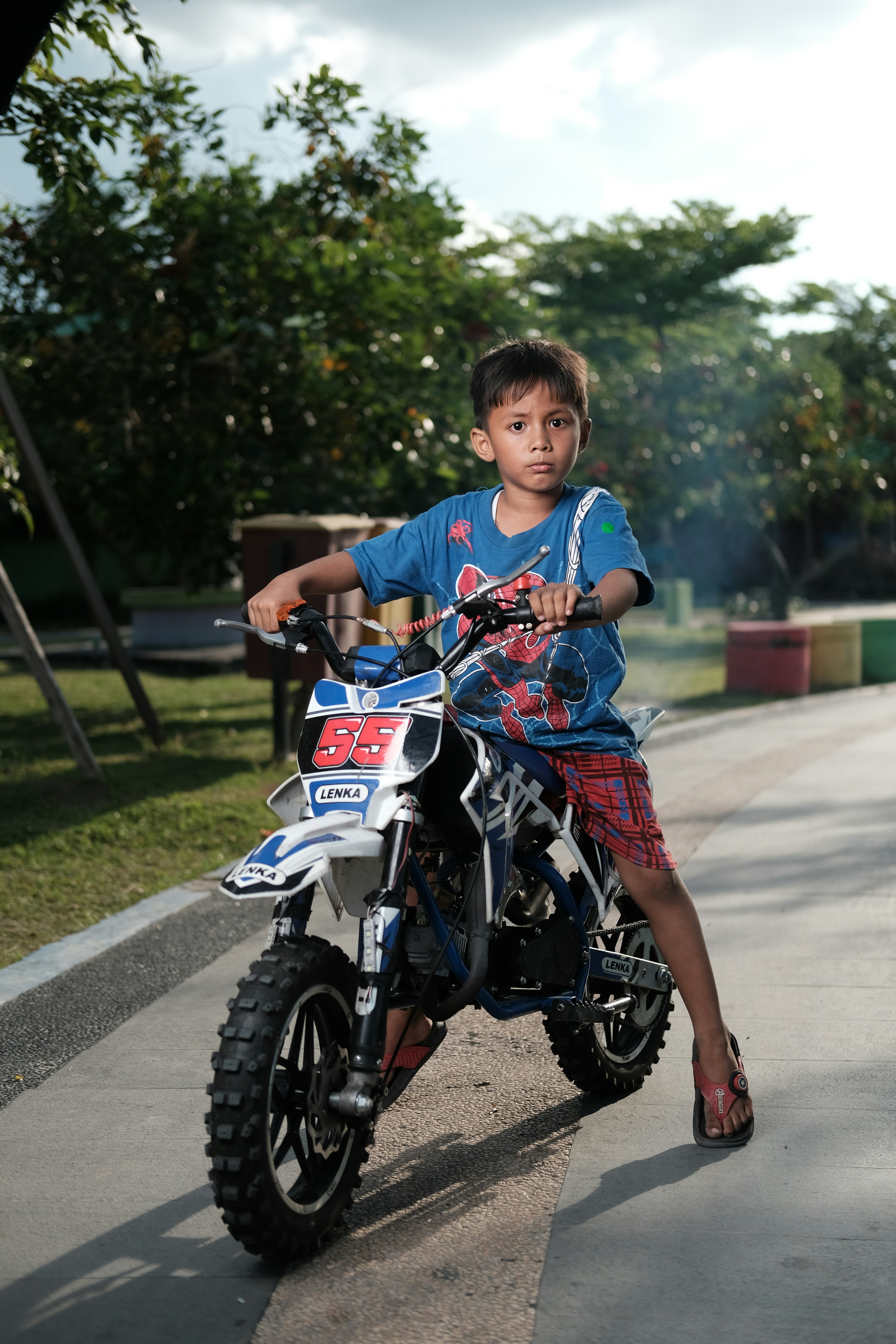 boy with motorcycle with sunset.