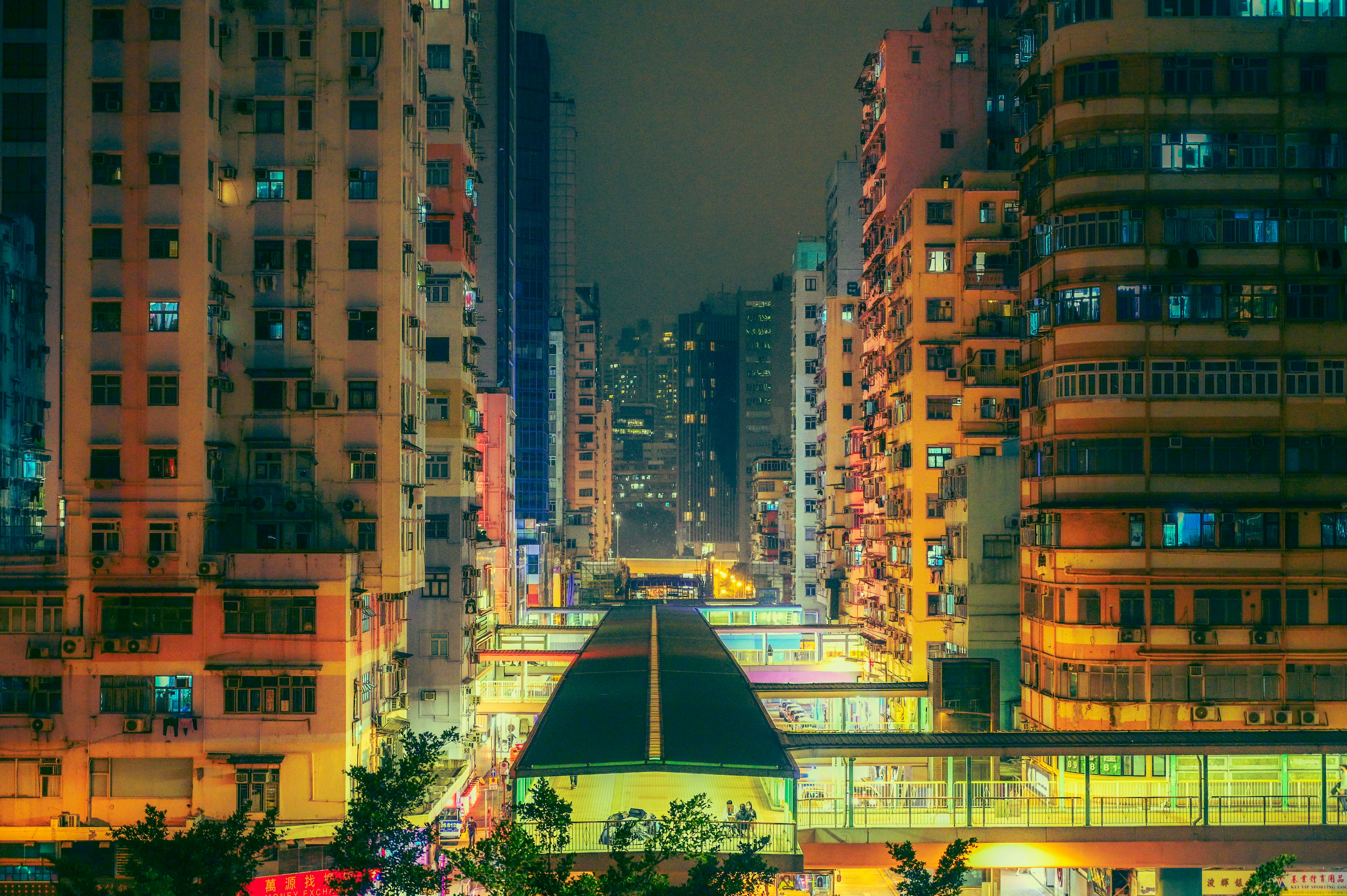 city buildings with lights turned on during night time