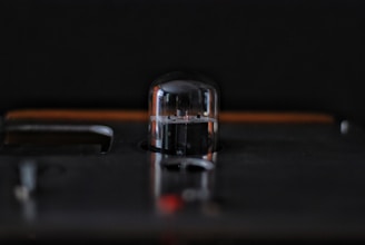 Close-up of a sleek electron beam evaporation source glowing softly inside a vacuum chamber.