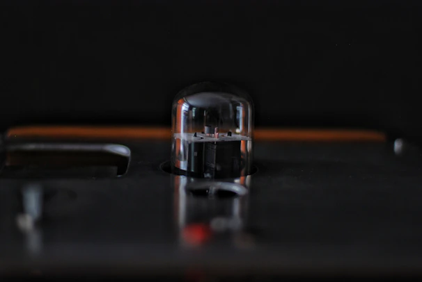 Close-up of Tube Preamplifier A showcasing vintage vacuum tubes glowing warmly inside a sleek chassis.