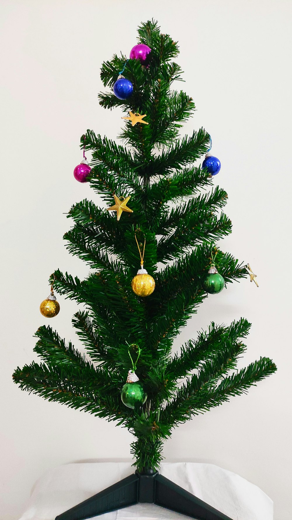 green christmas tree with yellow baubles