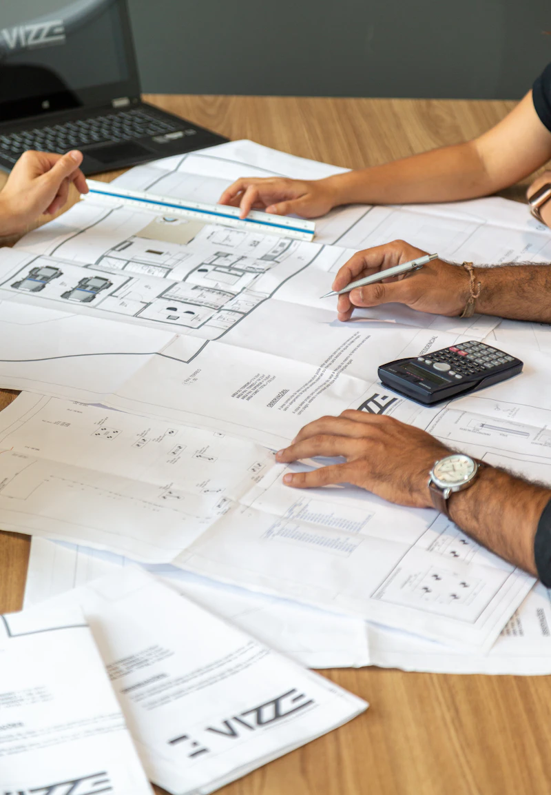 People reviewing architectural blueprints together