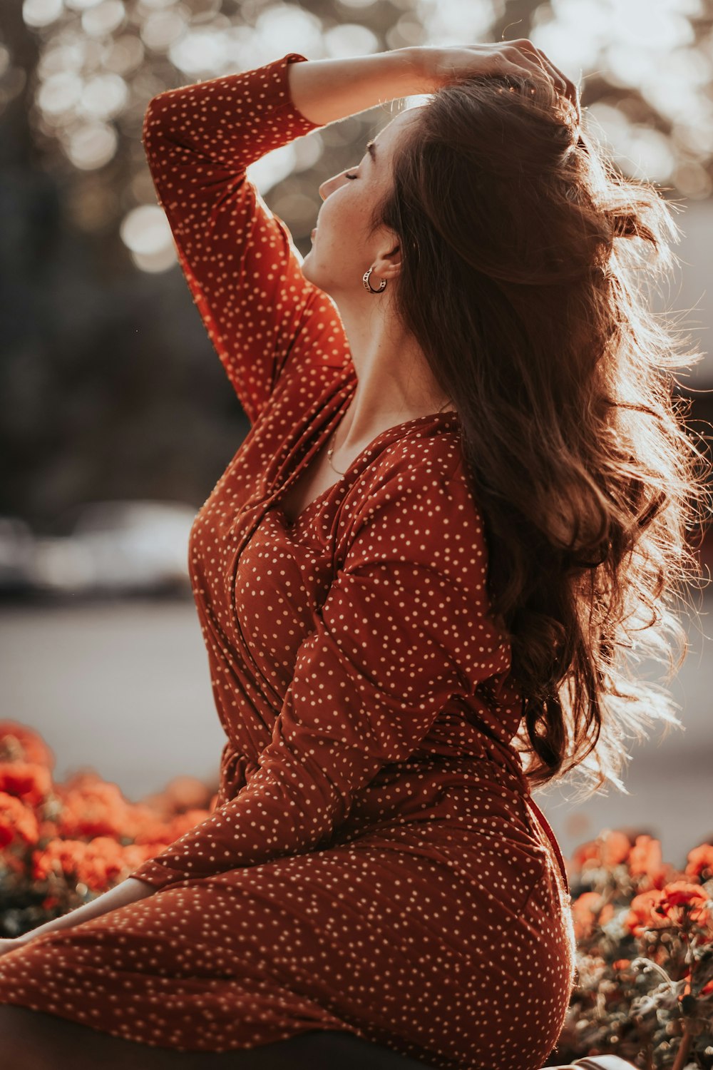 woman in red and white polka dot long sleeve dress