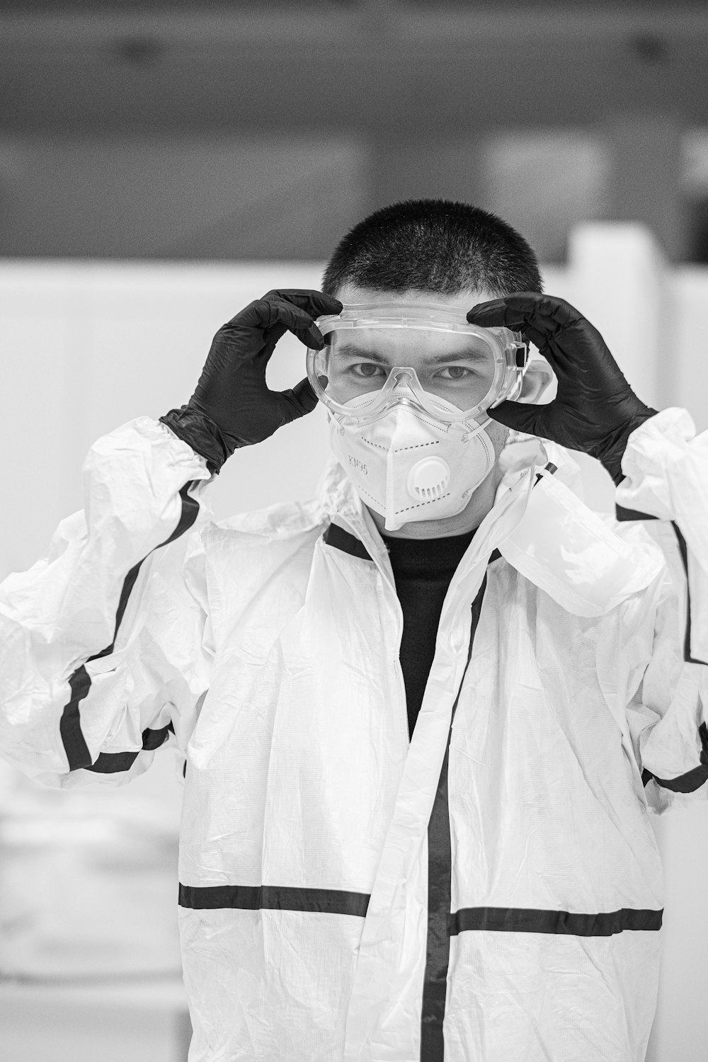 grayscale photo of woman in white robe wearing face mask