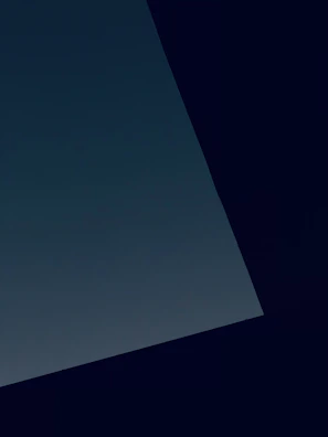 Minimalist composition of a lone figure silhouetted against a vast, dark background.