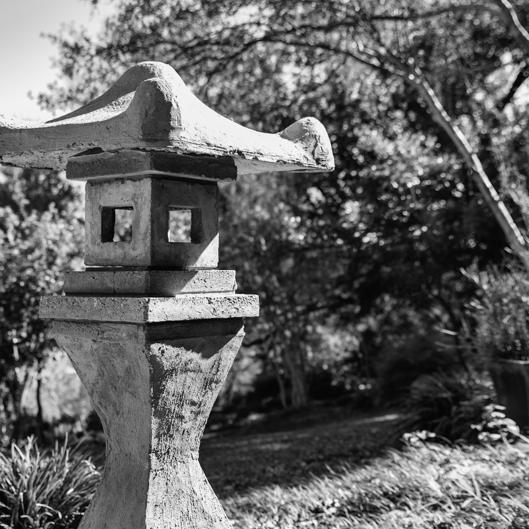 grayscale photo of concrete outdoor fountain