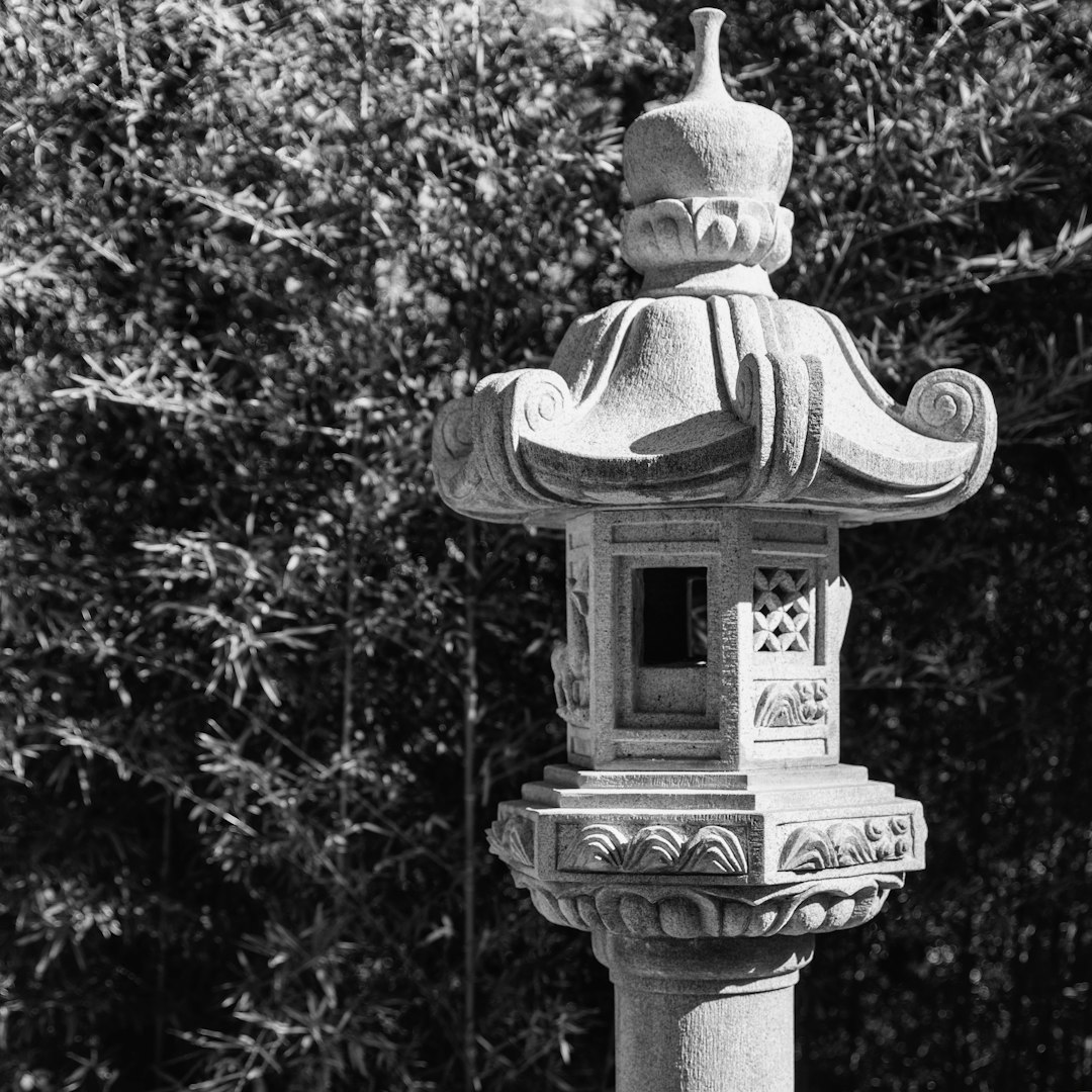 grayscale photo of concrete statue