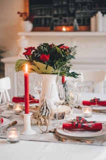 A stylish holiday table setting with aza-rosa gift bags and seasonal floral accents.