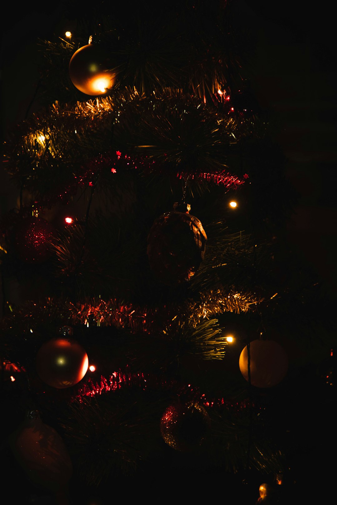 red and yellow baubles on christmas tree