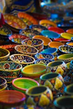 Array of colorful handmade bowls stacked loosely with textured stoneware and lively glazes.