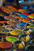 Vibrant ceramic bowls stacked neatly, showcasing rich textures and earthy tones.