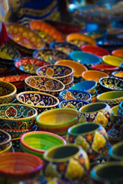 Colorful ceramic bowls stacked gently, showcasing vibrant glazes and rustic textures.