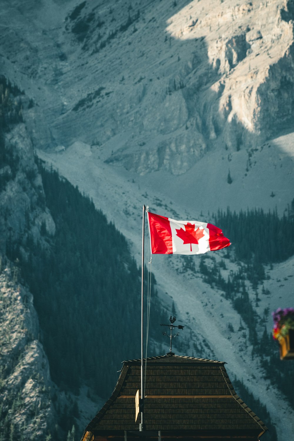 person in yellow jacket and yellow helmet holding red and white flag