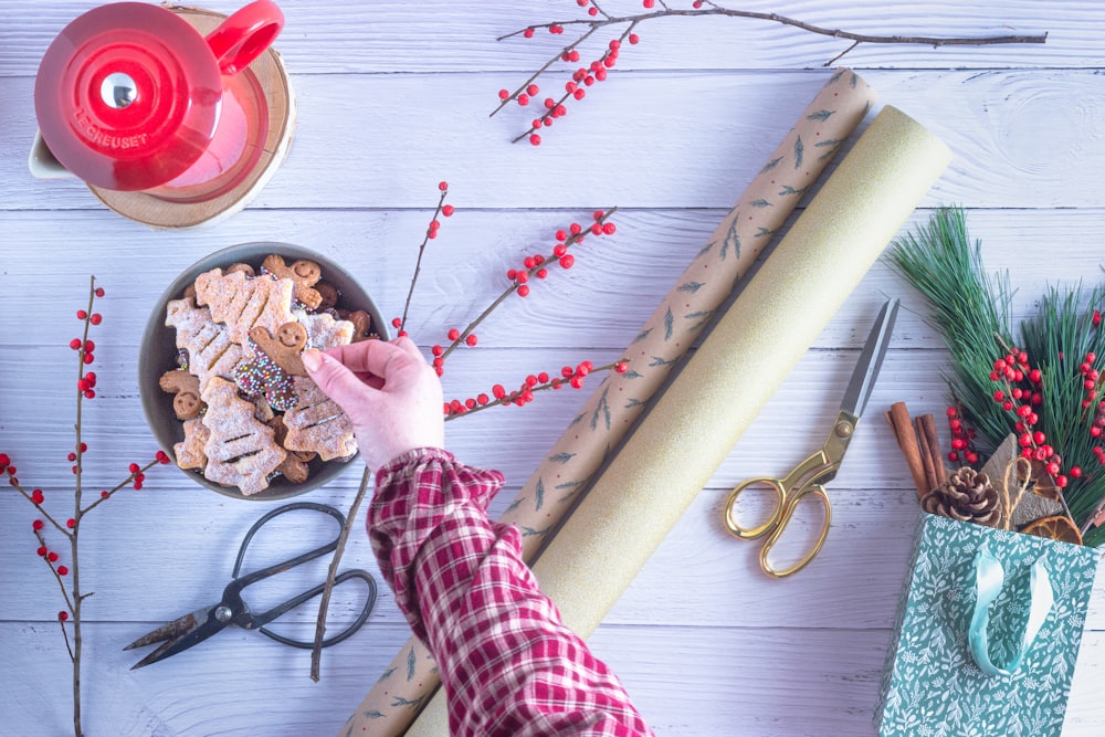 person holding brown wooden rolling pin