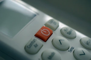 A variety of aircon remote controls neatly arranged on a counter