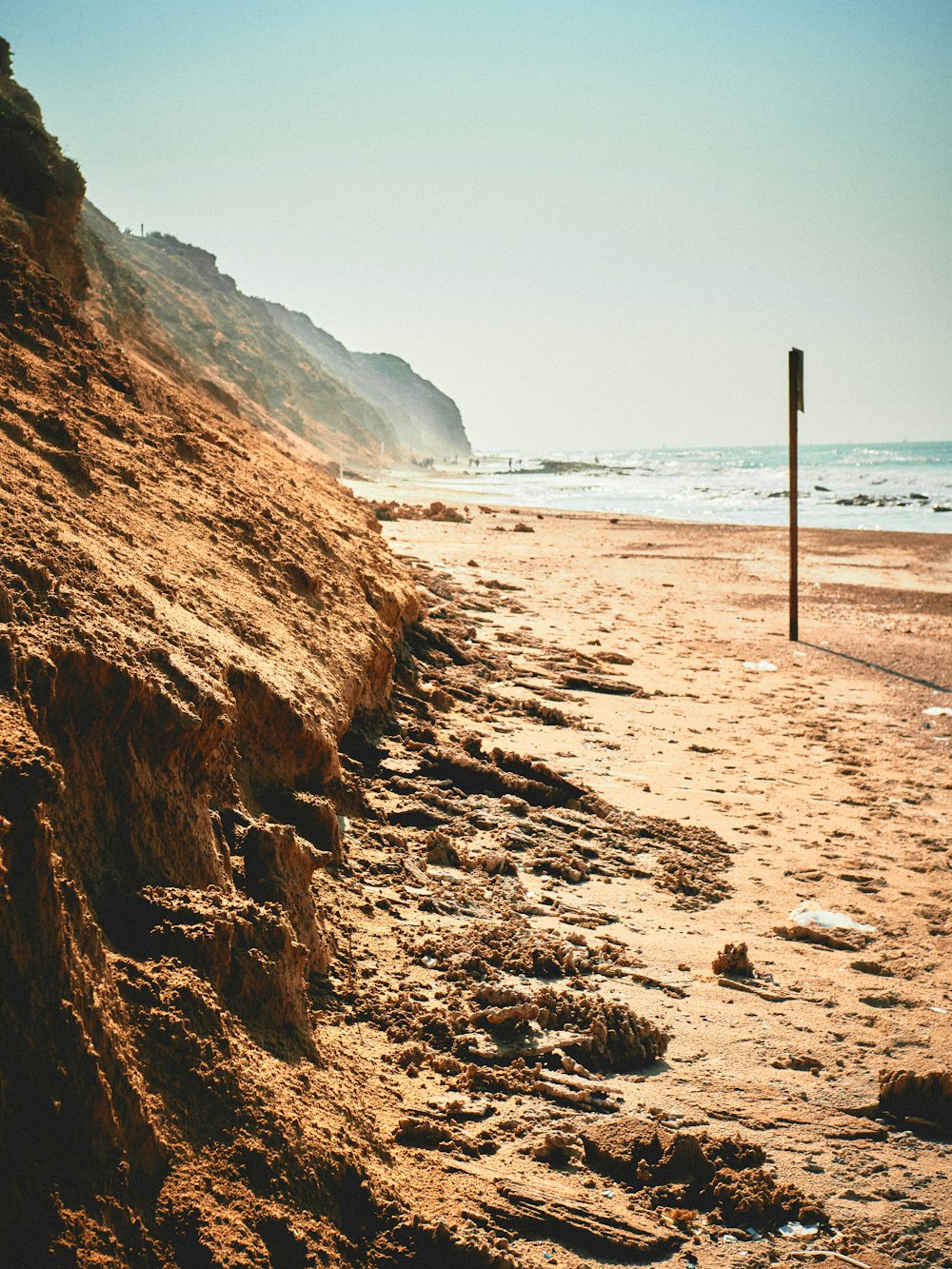 brown wooden poles on beach shore during daytime