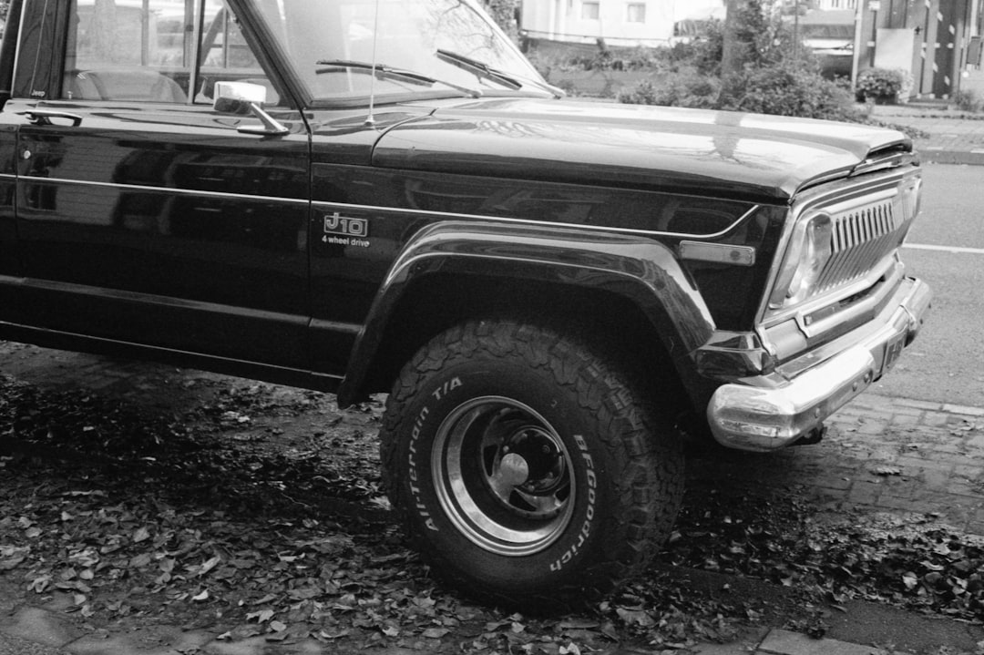 grayscale photo of car on road