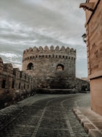 brown brick building under cloudy sky during daytime