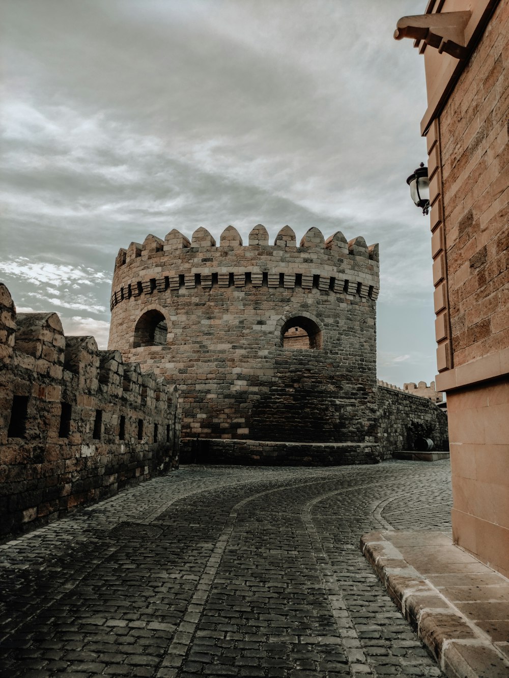 brown brick building under cloudy sky during daytime