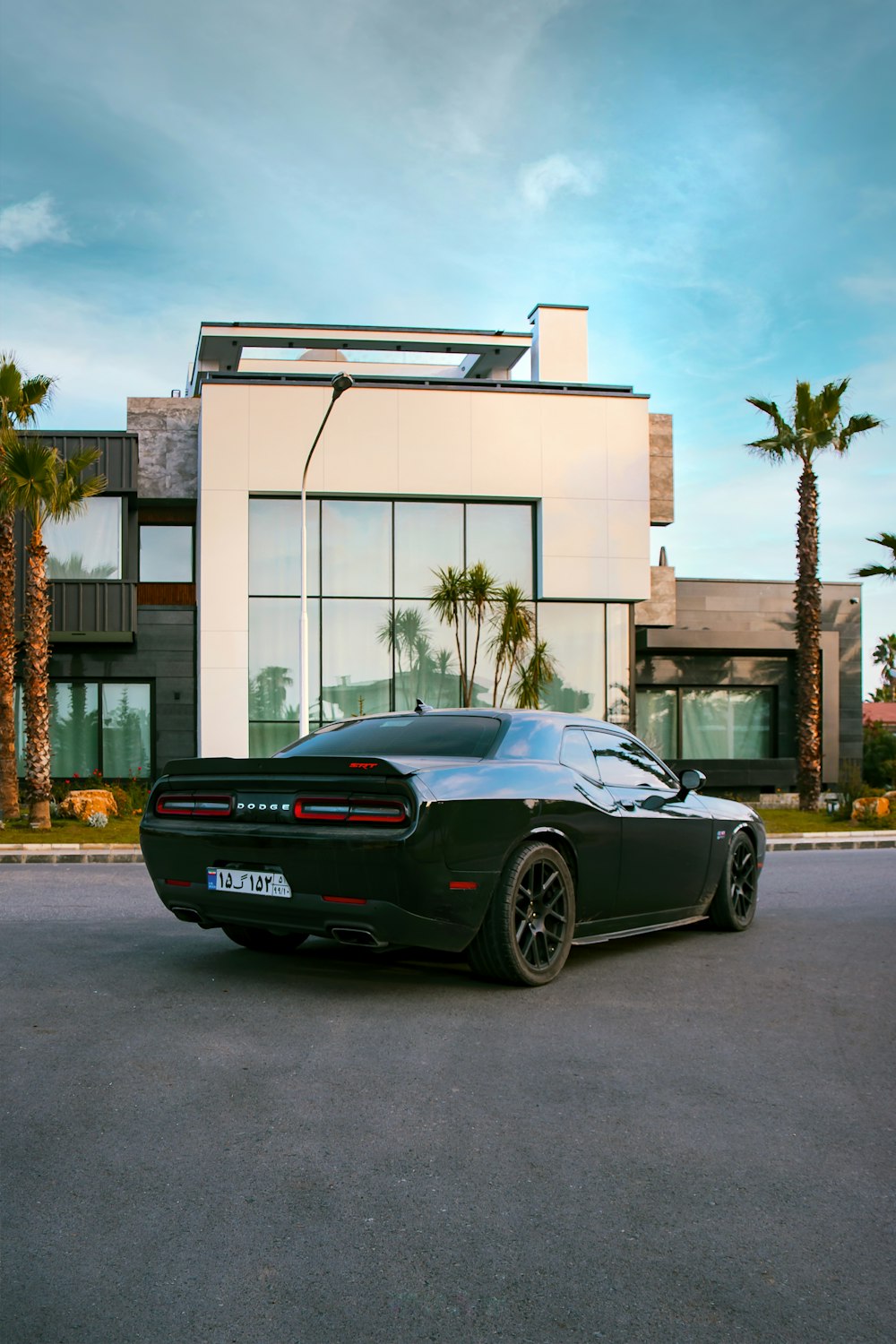 black porsche 911 parked in front of white building