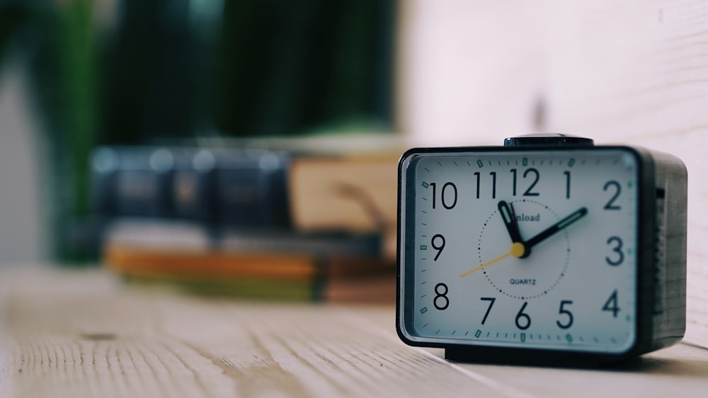 black and white analog clock at 10 10